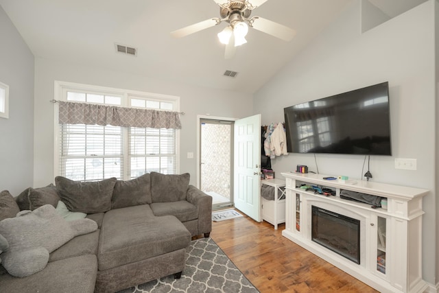 living room featuring lofted ceiling, wood-type flooring, and ceiling fan