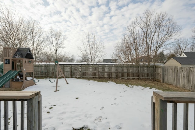 snowy yard with a playground