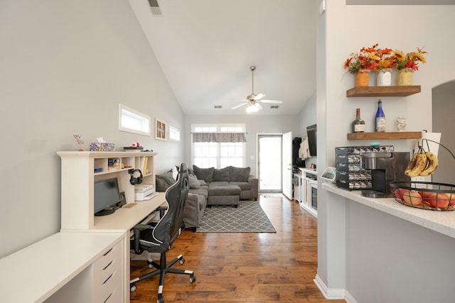 office space with dark wood-type flooring, ceiling fan, and high vaulted ceiling