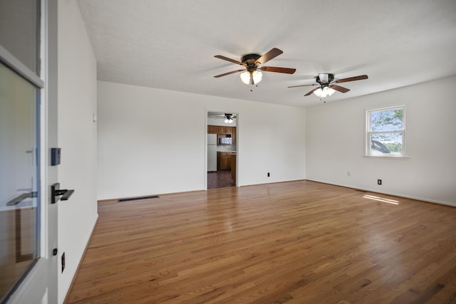 empty room with dark hardwood / wood-style flooring