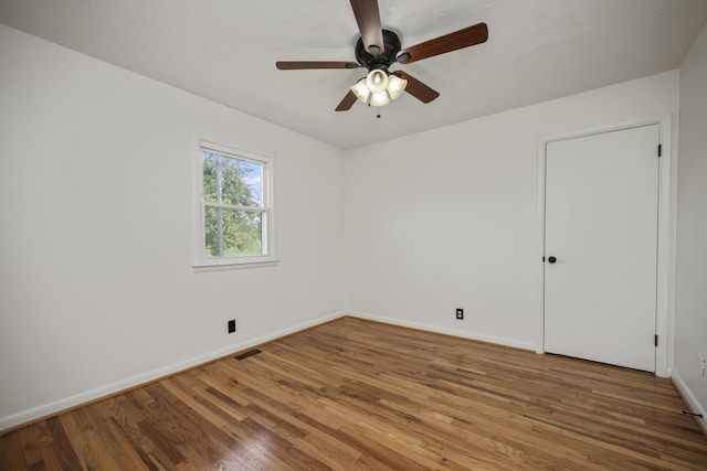 spare room with ceiling fan and wood-type flooring