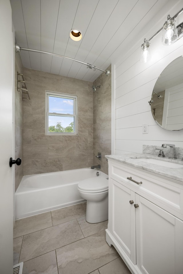 full bathroom with tiled shower / bath, vanity, and toilet