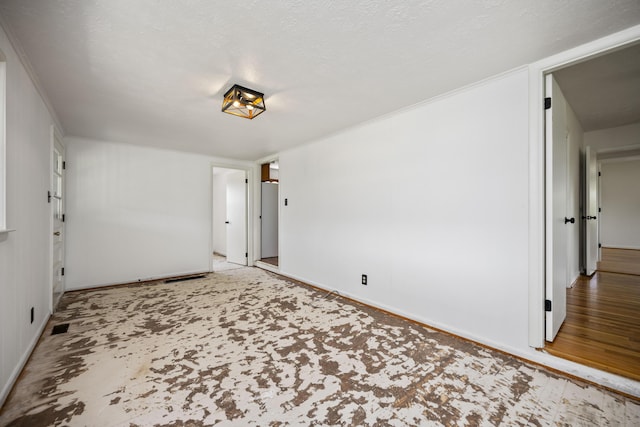 spare room with a textured ceiling