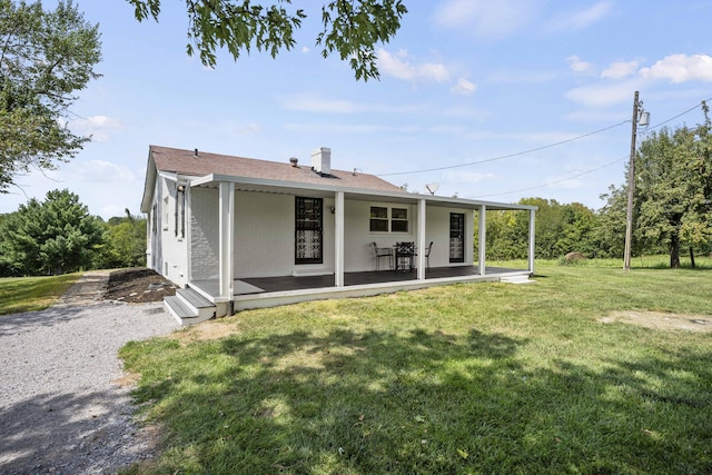 back of property with a lawn