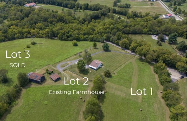 birds eye view of property featuring a rural view