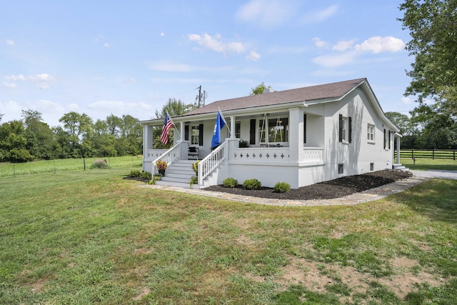 manufactured / mobile home with covered porch and a front lawn