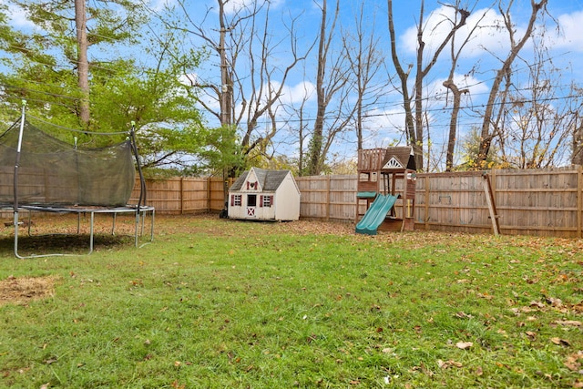 view of yard with a storage shed, a playground, and a trampoline