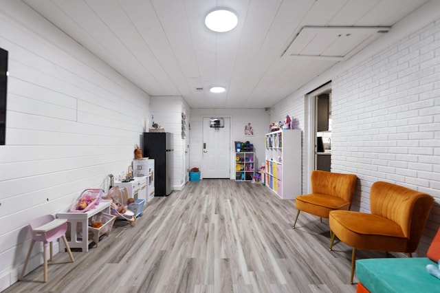 game room with light hardwood / wood-style floors