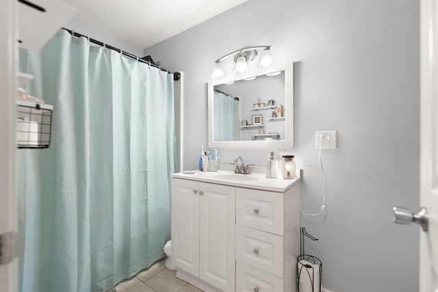 bathroom featuring tile patterned flooring, vanity, a shower with shower curtain, and toilet