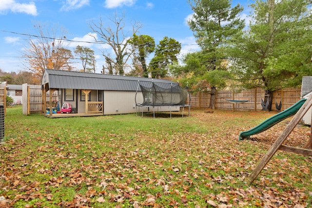 view of yard featuring a playground and a trampoline