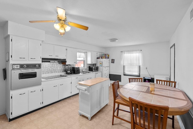 kitchen with white cabinetry, white appliances, ceiling fan, and backsplash