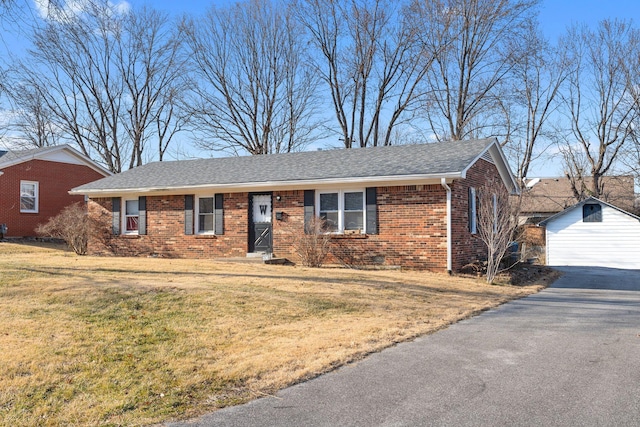 single story home with a garage, an outdoor structure, and a front yard