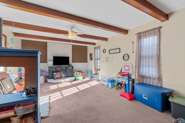 playroom featuring beamed ceiling, ceiling fan, and carpet