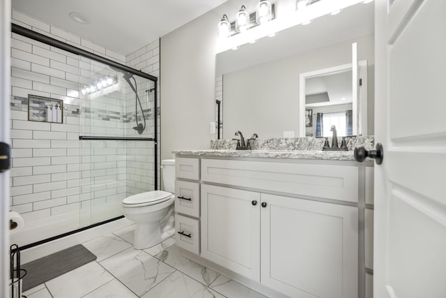 bathroom with vanity, toilet, and walk in shower