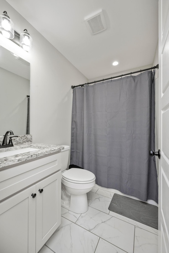 bathroom with vanity, walk in shower, and toilet