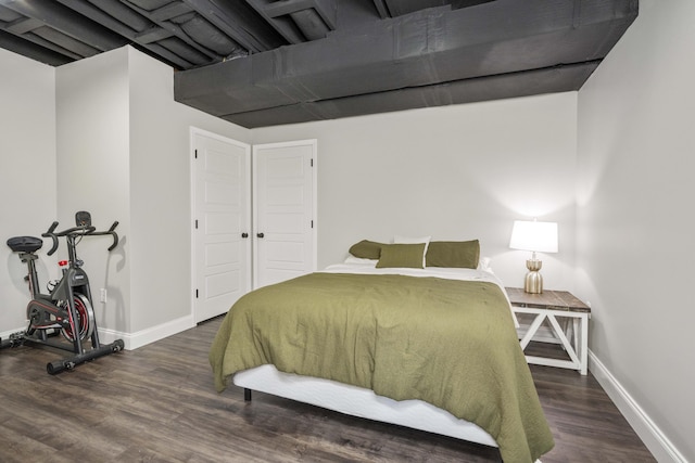 bedroom with dark hardwood / wood-style floors