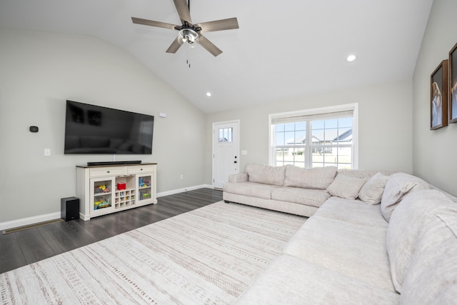 living room featuring ceiling fan, dark hardwood / wood-style floors, and vaulted ceiling