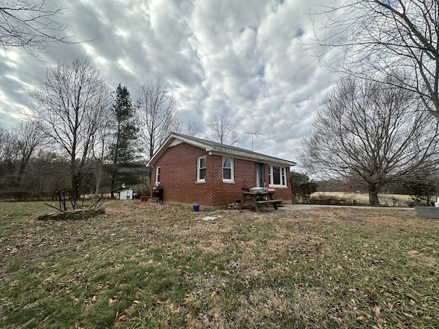 view of side of home featuring a lawn