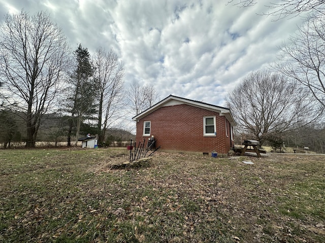 view of home's exterior with a lawn