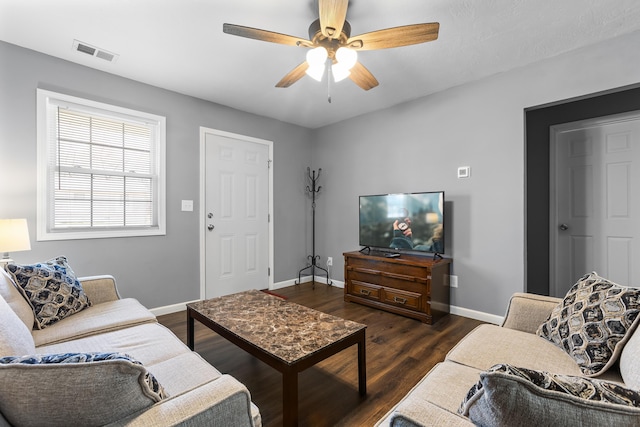 living room with ceiling fan and dark hardwood / wood-style flooring