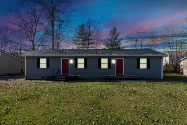 ranch-style home with a yard