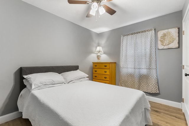 bedroom featuring hardwood / wood-style flooring and ceiling fan