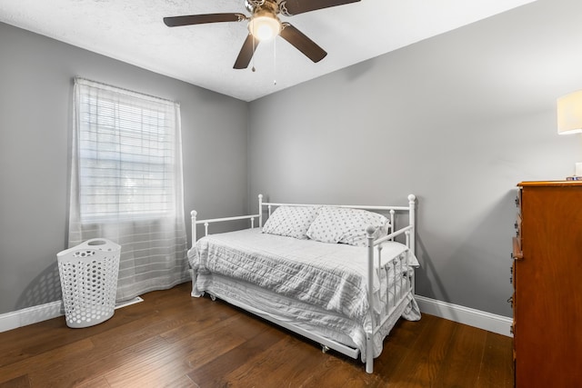 bedroom featuring dark hardwood / wood-style floors and ceiling fan