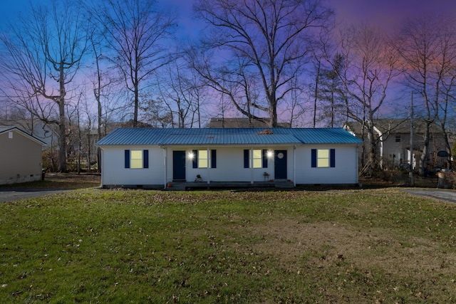 ranch-style home featuring a lawn