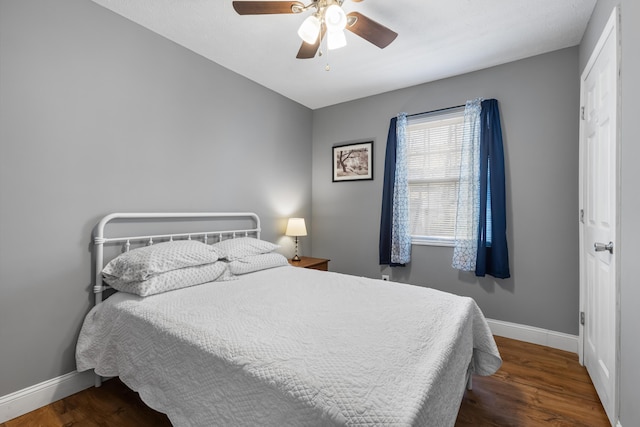 bedroom with ceiling fan and dark hardwood / wood-style flooring