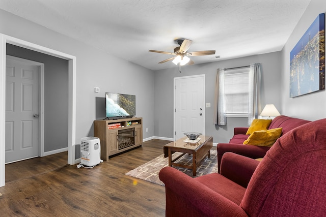 living room with dark hardwood / wood-style floors and ceiling fan