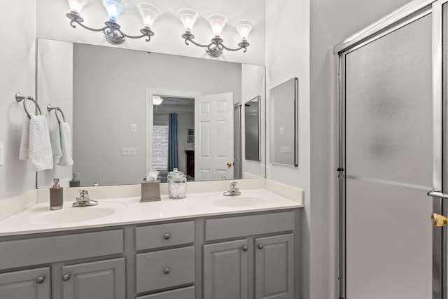 bathroom with vanity and a shower with shower door