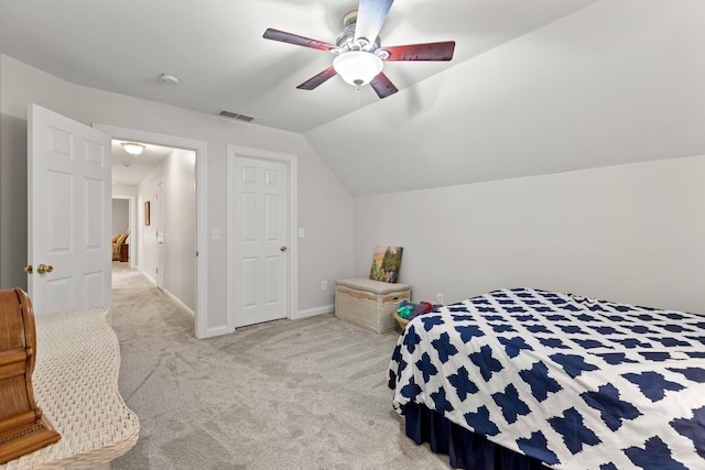 bedroom with ceiling fan, vaulted ceiling, and light carpet