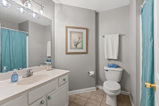 bathroom featuring vanity, toilet, and tile patterned flooring