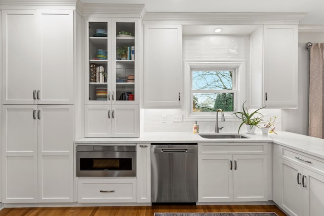 kitchen with sink, stainless steel dishwasher, and white cabinets