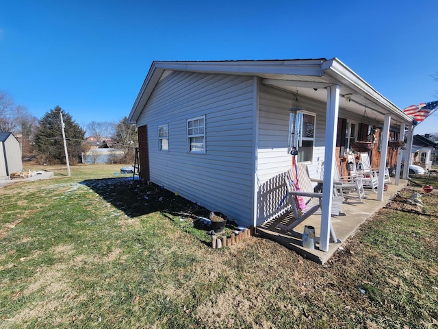 view of side of property with a lawn