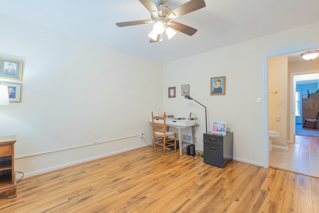 office with ceiling fan and light hardwood / wood-style floors