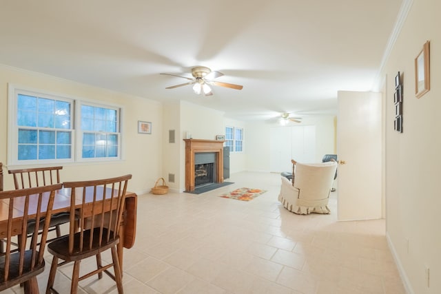 living room with ceiling fan, ornamental molding, and a wealth of natural light