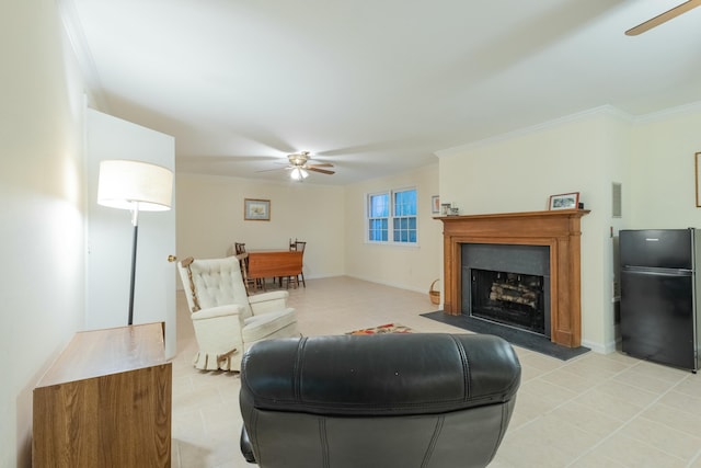 living room featuring light tile patterned floors, ornamental molding, and ceiling fan