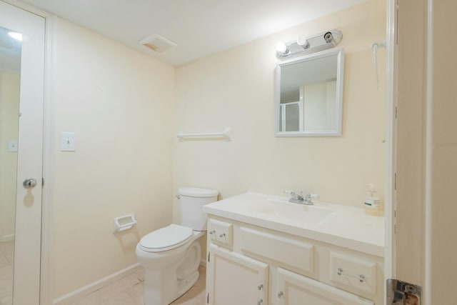 bathroom with vanity, toilet, and tile patterned flooring