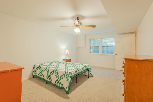 bedroom featuring light colored carpet and ceiling fan