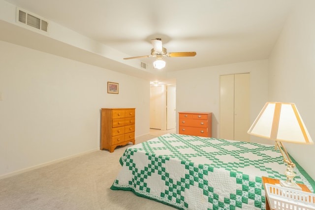 bedroom with light colored carpet, a closet, and ceiling fan