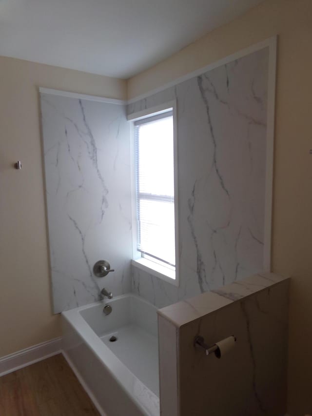 bathroom featuring hardwood / wood-style flooring and a healthy amount of sunlight