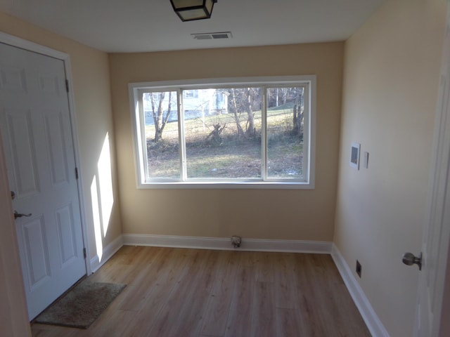 unfurnished dining area with light wood-type flooring