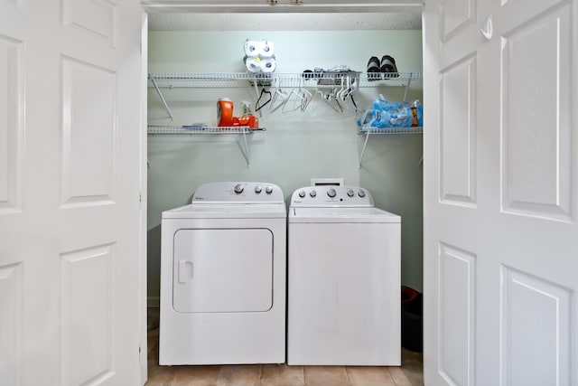 clothes washing area featuring independent washer and dryer and a textured ceiling