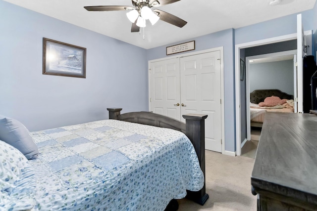 bedroom featuring light colored carpet, a closet, and ceiling fan