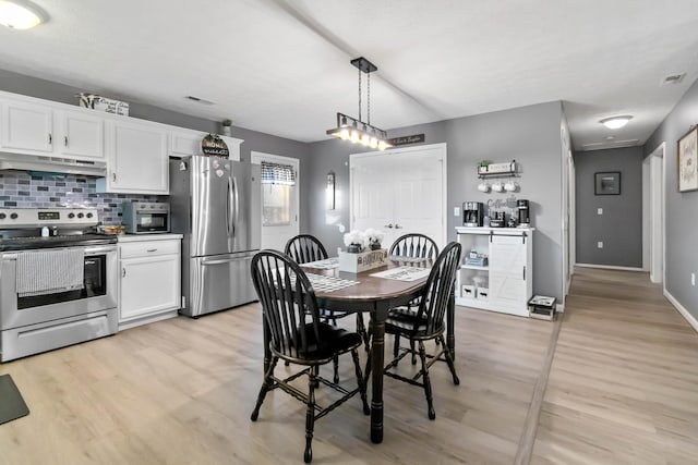 dining space with light hardwood / wood-style floors