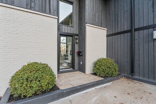 property entrance featuring brick siding