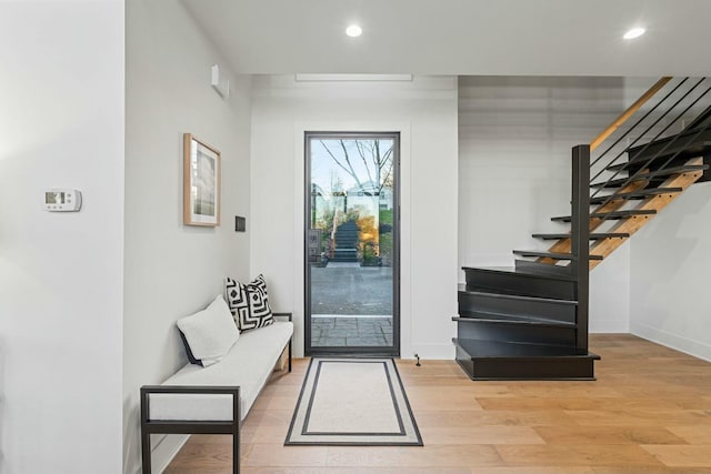 doorway to outside with stairway, recessed lighting, light wood finished floors, and baseboards