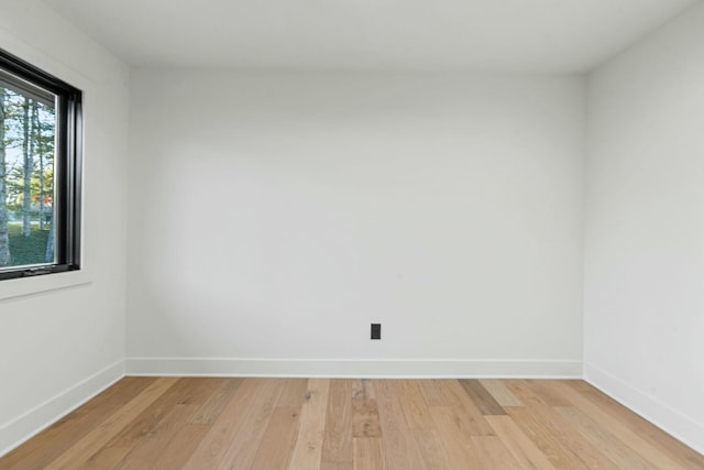 unfurnished room featuring light wood-style floors and baseboards