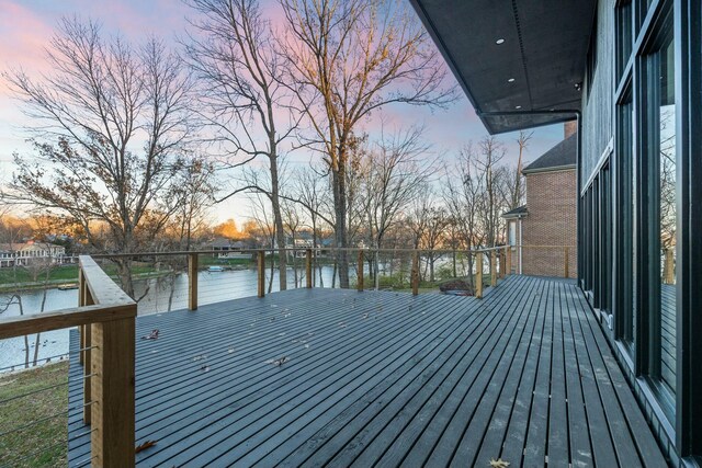 dock area featuring a deck with water view